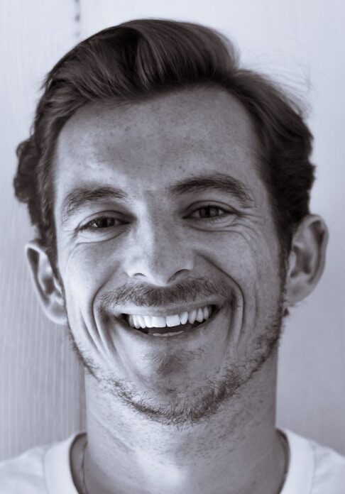 grayscale photography of man smiling